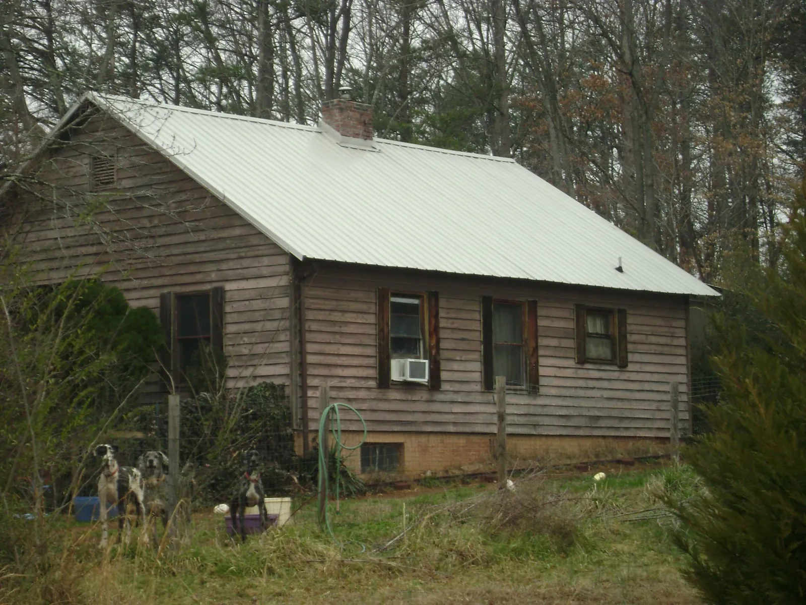 White metal roof on an old wood sided farmhouse, from a Metal Roof Installation job in Mount Hope